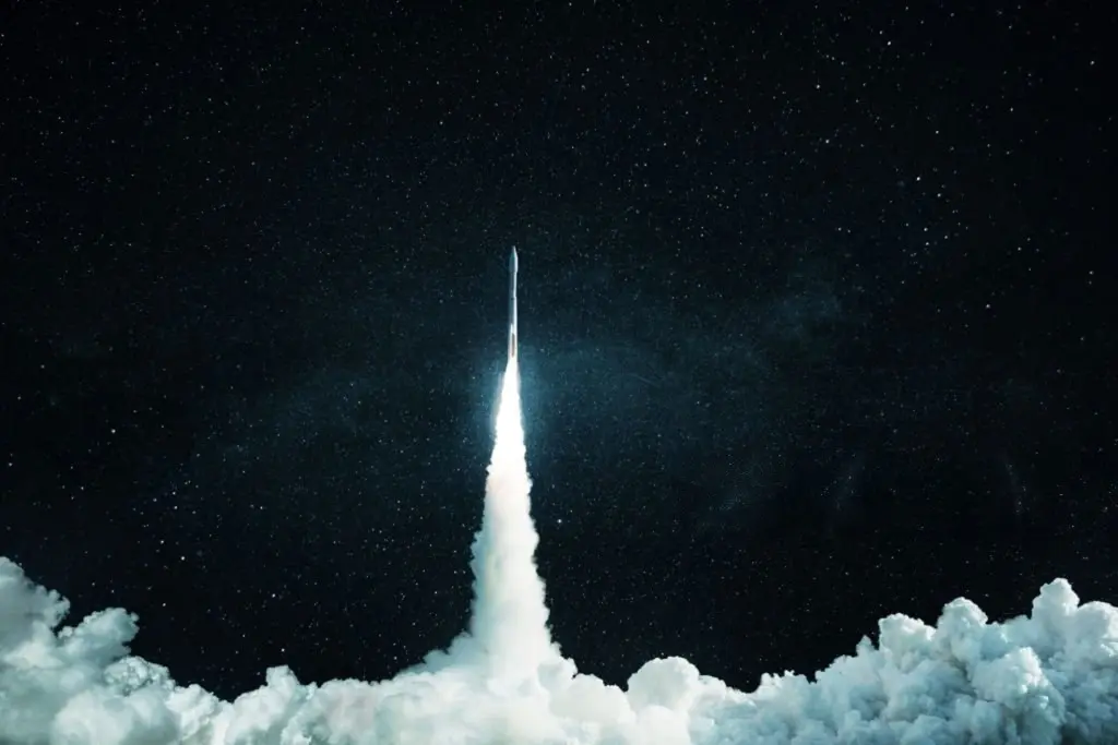 A rocket lifting off into a starry night sky